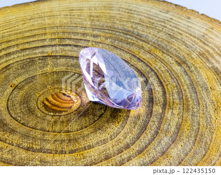 Pink crystal crystal on a wooden surface Pink crystal crystal on a wooden surface 122435150