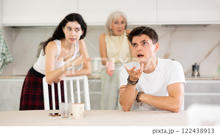 Elderly woman mother and young girl during family quarrel accuse adult son Elderly woman mother and young girl during family quarrel accuse adult son 122438913