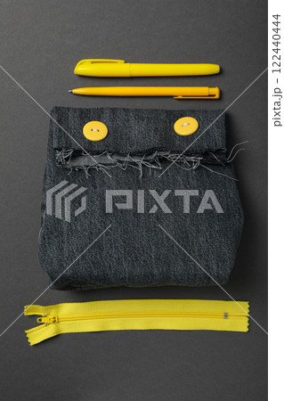 Denim handmade bag, tools and materials on gray background, top view 122440444