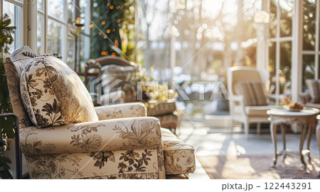 Colorful pillows on sofa against glass wall of window in a winter garden or conservatory. Interior textile concept. High quality photo 122443291