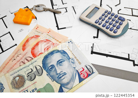 Singaporean Dollar banknotes on the top of building plans Singaporean Dollar banknotes on the top of building plans 122445354