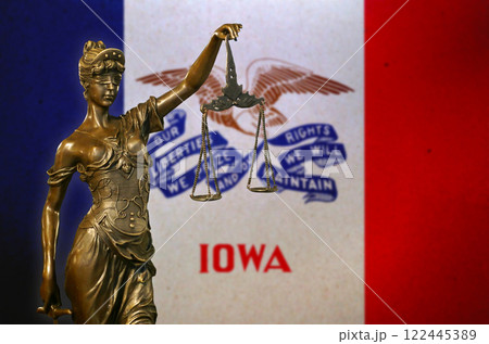 Lady Justice before a flag of Iowa Lady Justice before a flag of Iowa 122445389