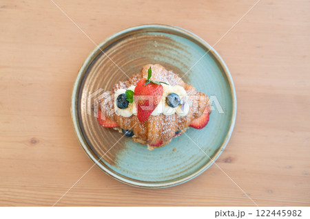 Fresh Strawberry and Blueberry Cream Croissant on a Rustic Ceramic Plate Fresh Strawberry and Blueberry Cream Croissant on a Rustic Ceramic Plate 122445982