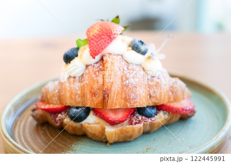 Fresh Strawberry and Blueberry Cream Croissant on a Rustic Ceramic Plate Fresh Strawberry and Blueberry Cream Croissant on a Rustic Ceramic Plate 122445991