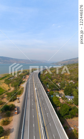 The M6  motorway Expressway Nakhon Ratchasima Province - Bang Pa-in. Lam Ta Khong River and Mountain. Drone shot of scenic landscape rural place traffic. Nakhon Ratchasima Thailand. Motorway Korat 122446876