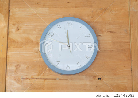 Wall Clock on Wooden Background 122448083