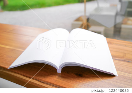 Blank White Book on Wooden Table Blank White Book on Wooden Table 122448086