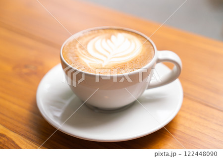 Hot Cappuccino with Latte Art on Wooden Table 122448090