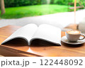Open Blank Book and Cappuccino on Wooden Table in Cozy Cafe 122448092