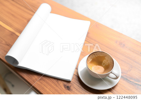 Open Blank Book and Cappuccino on Wooden Table in Cozy Cafe 122448095