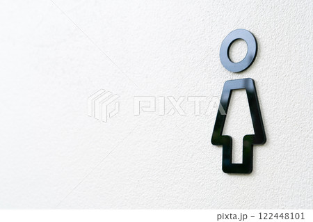 Minimalist Female Restroom Sign on a White Wall 122448101