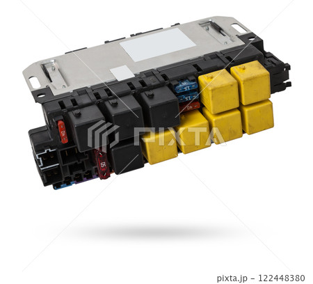 Fuse box and black relay in the car's electrical circuit during vehicle repair in the workshop. Auto service industry. 122448380