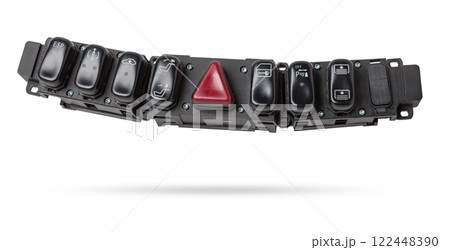 Black plastic block of car control panel with red emergency stop button for signal lights, spare part on a white isolated background in a photo studio for sale and installation in a auto service. Black plastic block of car control panel with red emergency stop button for signal lights, spare part on a white isolated background in a photo studio for sale and installation in a auto service. 122448390