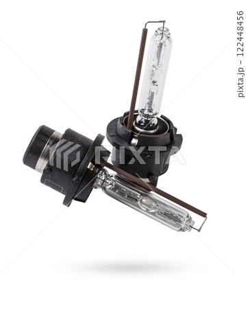 Automotive electric parts - New white 12v xenon headlight car lamp on the white background - gas discharge lamp. Spare parts auto catalog. 122448456