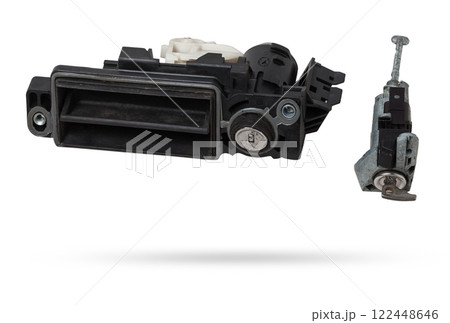 Detail of a car spare part made of black plastic and metal - keyhole lock with key for opening the trunk separately, isolated on a white background. Repair in a car workshop, equipment for sale. Detail of a car spare part made of black plastic and metal - keyhole lock with key for opening the trunk separately, isolated on a white background. Repair in a car workshop, equipment for sale. 122448646