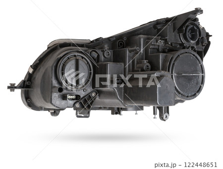 Stylish xenon headlight of a German car - optical equipment with a lamp inside on a white isolated background. Spare part for auto repair in a car workshop. Stylish xenon headlight of a German car - optical equipment with a lamp inside on a white isolated background. Spare part for auto repair in a car workshop. 122448651