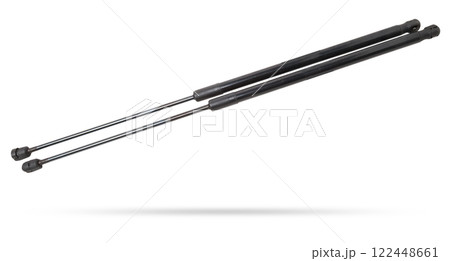 A pair of black metal hood shock absorbers with chrome elements - detail of a car mechanism on a white isolated background. Spare parts for body repair. A pair of black metal hood shock absorbers with chrome elements - detail of a car mechanism on a white isolated background. Spare parts for body repair. 122448661