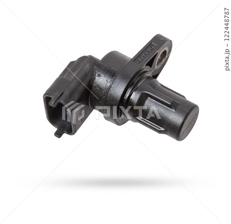 Electromagnetic crankshaft position sensor of a car engine in the hands of an auto mechanic. Spare parts catalog. Electromagnetic crankshaft position sensor of a car engine in the hands of an auto mechanic. Spare parts catalog. 122448787