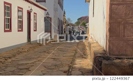 Walking through colorful cobblestone street in colonial Brazilian town 122449367