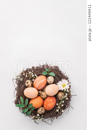 Easter nest with hand-painted eggs on a light background Easter nest with hand-painted eggs on a light background 122449411