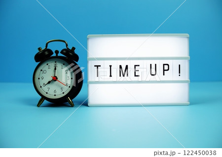 Time Up! letterboard text on LED Lightbox and alarm clock on blue background Time Up! letterboard text on LED Lightbox and alarm clock on blue background 122450038
