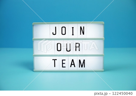 Join Our Team letterboard text on LED Lightbox on blue background 122450040