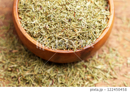 Wooden bowl filled with medicinal dried horsetail plant parts. Herbal leaves and stems. Healing herbs concept. Macro 122450458