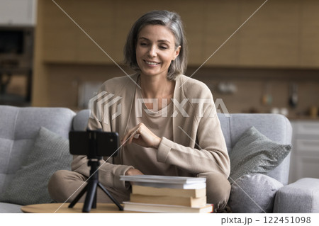 Mature female blogger influencer record video content to literature blog Mature female blogger influencer record video content to literature blog 122451098