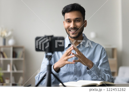 Smiling gen z man vlogger record content use cellphone webcam 122451282
