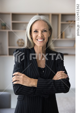 Successful mature businesslady posing in office, vertical portrait 122451362