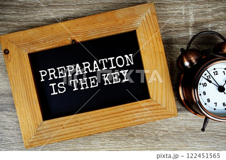 Preparation is the key text on wooden board with alarm clock on wooden background Preparation is the key text on wooden board with alarm clock on wooden background 122451565