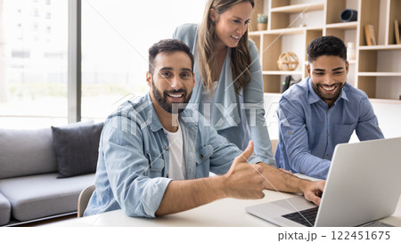 Man showing thumbs-up, gesture of approval or satisfaction with teamwork Man showing thumbs-up, gesture of approval or satisfaction with teamwork 122451675