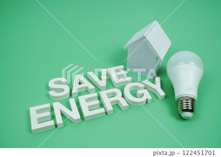 Save Energy alphabet letters with house model and LED light bulbs on green background, Saving and Eco friendly concept 122451701