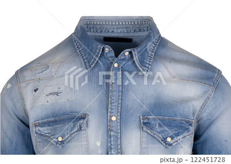 Front view close up of a light blue distressed denim shirt with patch details and buttoned pockets Front view close up of a light blue distressed denim shirt with patch details and buttoned pockets 122451728