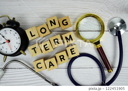 Long term care with wooden blocks alphabet letters and stethoscope on wooden background, Healthy and wellness concept 122451905