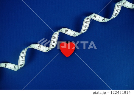 Red Heart with white measure tape on navy blue background, Healthy concept 122451914