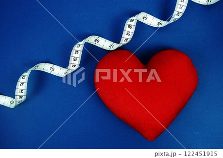 Red Heart with white measure tape on navy blue background, Healthy concept 122451915