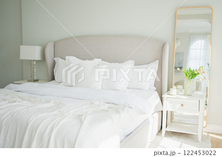 Stylish loft bedroom interior. Spacious design apartment with light walls large windows big bed. Clean modern decoration with elegant furniture in minimalist Scandinavian style Stylish loft bedroom interior. Spacious design apartment with light walls large windows big bed. Clean modern decoration with elegant furniture in minimalist Scandinavian style 122453022