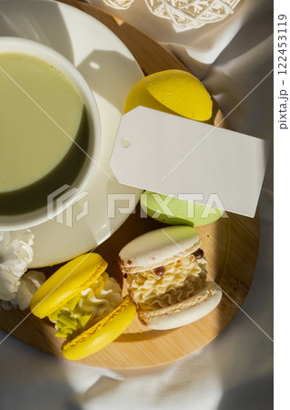 Mock up paper note sample copy space Green latte matcha and sweet macaron on messy bed. Concept of holiday breakfast morning tea drink. Cozy minimalist superfood vibrant colors healthy eating. Organic Mock up paper note sample copy space Green latte matcha and sweet macaron on messy bed. Concept of holiday breakfast morning tea drink. Cozy minimalist superfood vibrant colors healthy eating. Organic 122453119