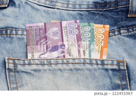 Gambian dalasi in the pocket of blue jeans Gambian dalasi in the pocket of blue jeans 122453367