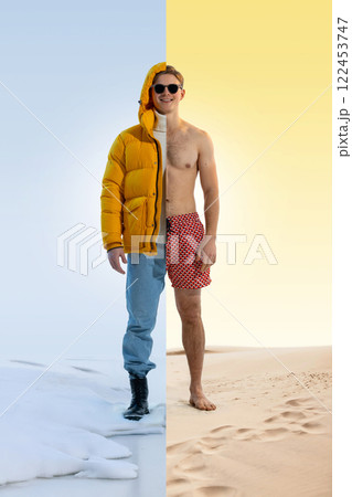 Smiling young man dressed in yellow winter jacket on one side and swim trunks on other, standing between ice and desert 122453747