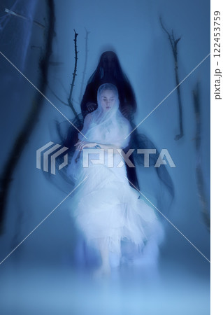 Elegant and ghostly, ballet dancers move as one, their translucent veils merging with spectral light. Duet of beauty and mystery. 122453759