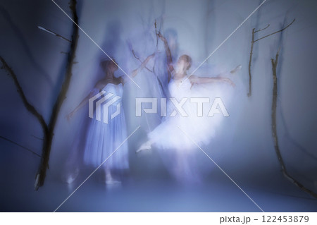 Two phantom dancers, graceful ballerinas wrapped in flowing veils, dancing mysterious ballet. 122453879