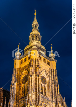 St Vitus Cathedral in Prague Castle is beautifully illuminated under a night sky, showcasing its stunning architecture and intricate details. St Vitus Cathedral in Prague Castle is beautifully illuminated under a night sky, showcasing its stunning architecture and intricate details. 122454453