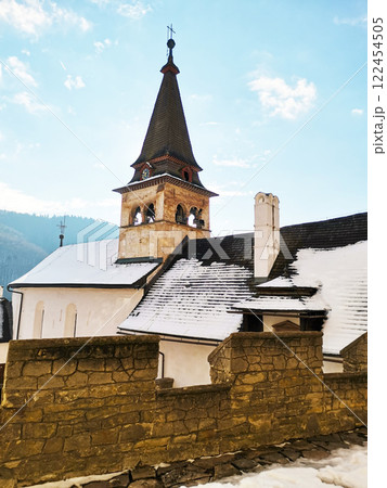Church tower with cross in medieval castle 122454505