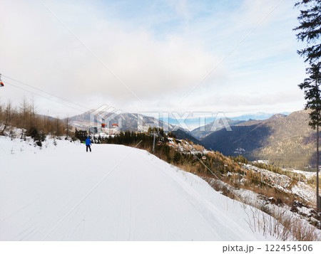 Skier descends from mountain 122454506