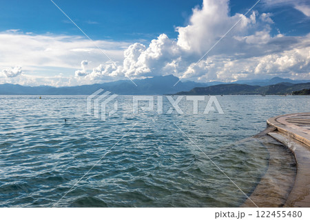 Lake Garda with mountains in background, view from Lazise town shore, Italy, Europe 122455480