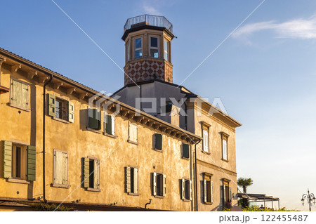 Old house with lighthouse in Lazise town on shore of Lake Garda. at sunset, Italy, Europe. 122455487