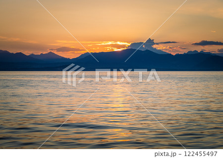 Lake Garda with mountains in background at sunset, view from Lazise town shore, Italy, Europe. 122455497
