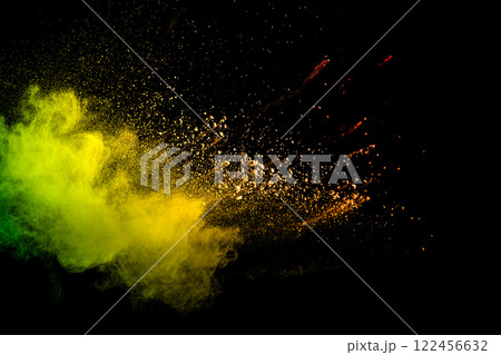 Colorful explosion of powdery dust is captured in a yellow and green cloud Colorful explosion of powdery dust is captured in a yellow and green cloud 122456632